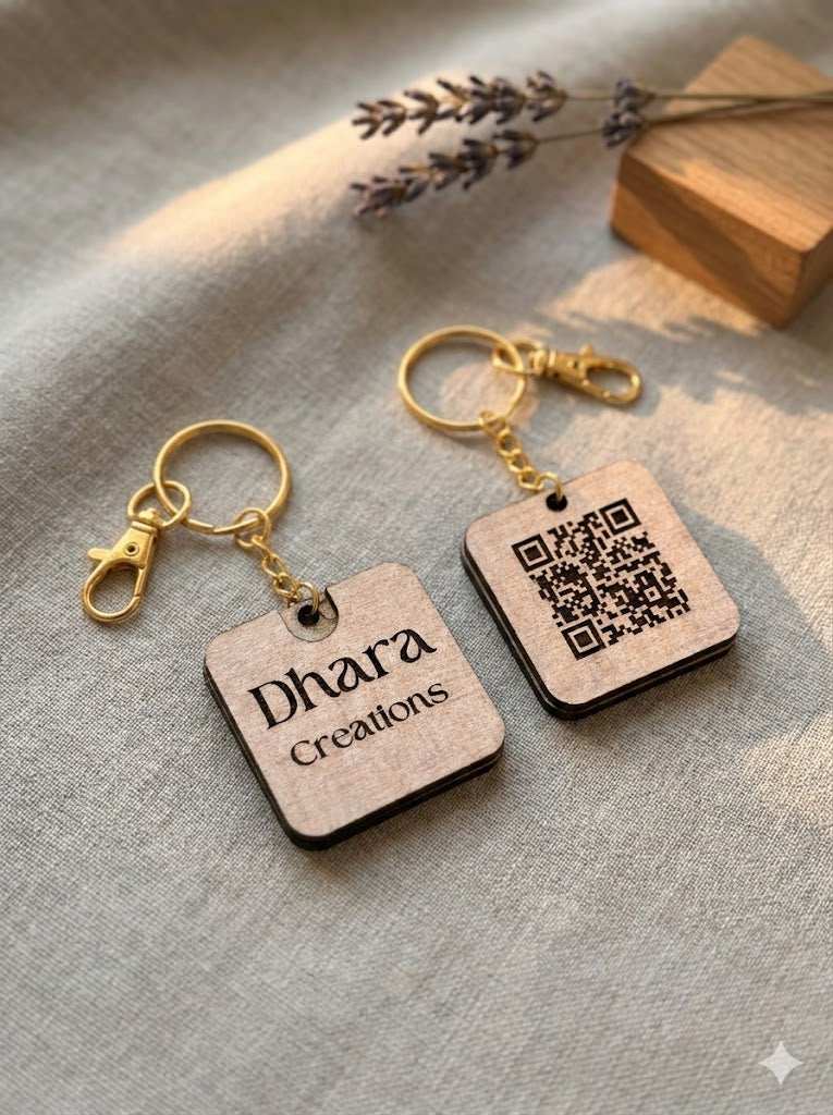 Custom wood keychain with Dhara Creations engraved on front and QR code on back