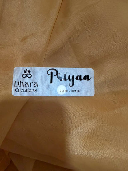 Marble acrylic name badge with Dhara Creations logo and Priyaa Maker Owner engraved